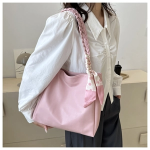 Pink tote bag with woven shoulder strap and decorative printed silk scarf detail