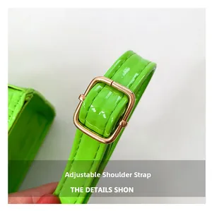 Close-up of bright green crocodile pattern leather with adjustable golden metal buckle