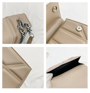 Detail of silver metal chain strap and magnetic clasp on beige quilted shoulder bag