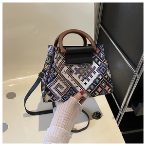 Ethnic style woven handbag with wooden handles and colorful geometric patterns