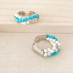 Bohemian silver hoop earrings featuring turquoise and white beaded rows in a chic style