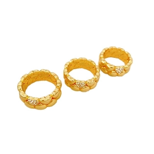 Three stackable gold heart rings with pavé crystals on white minimalist background