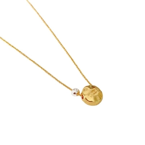 Hammered gold pendant necklace with silver bead and engraved text on a minimalist chain