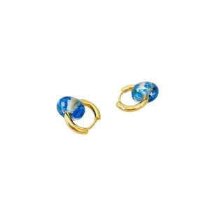 Fashion gold hoop earrings with blue floral resin beads on a clean white background