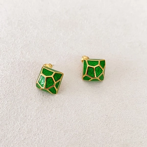 Detailed macro view of square gold studs with dark green geometric enamel inlay