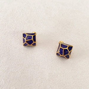 Square geometric blue enamel stud earrings with gold trim and textured pattern