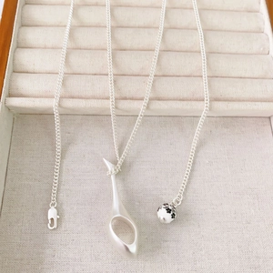 Minimalist silver perfume bottle pendant necklace with abstract hollow design and floral bead
