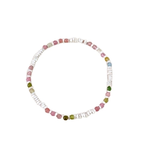 Colorful tourmaline beaded bracelet with irregular silver spacer beads on white background