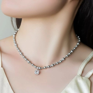 Elegant gray pearl necklace with square crystal pendant worn on a model for a chic look