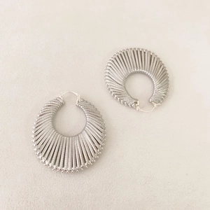 Pair of vintage silver textured hoop earrings with radial ribbed patterns and clasp closure