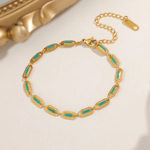 Detailed macro shot of vintage gold titanium steel bracelet with oval turquoise resin