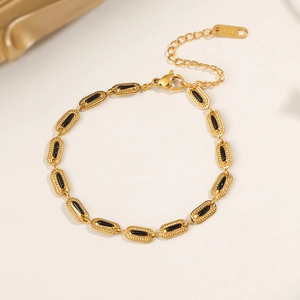 18K gold plated titanium bracelet with black oval charms and adjustable lobster clasp