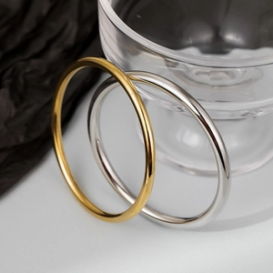 Minimalist 4mm titanium steel bangles in gold and silver finish on silk fabric