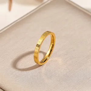 Gold plated kaleidoscope four-leaf clover ring with detailed floral embossing texture