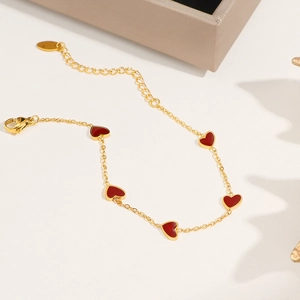 Golden titanium steel bracelet with five red enamel heart charms and adjustable lobster clasp