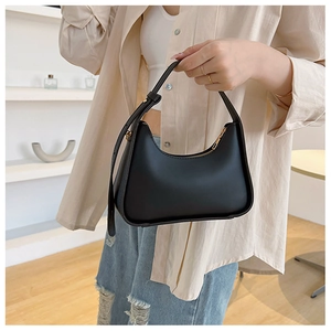 Close-up of black hobo bag with adjustable handle and golden zipper detail