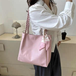 Pink faux leather tote bag with woven handles and cherry print silk scarf detail