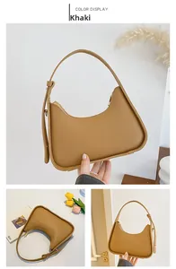 Detail view of khaki crescent underarm bag with matte texture and adjustable metal buckle