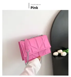 Detail of pink quilted chain bag with geometric embossing and silver metal strap