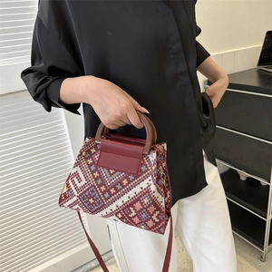 Ethnic woven handbag with colorful geometric patterns and elegant wooden top handles