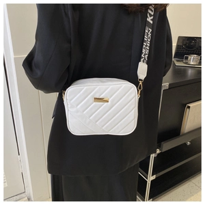 White quilted crossbody camera bag with adjustable jacquard strap and gold hardware