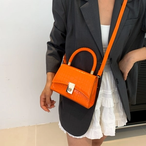 Bright orange crocodile pattern handbag with silver twist lock and woven handle for women