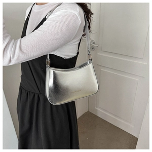 Silver glossy shoulder bag featuring Fashion & Bags logo shown on a model's arm