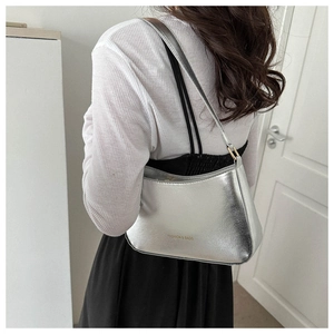 Silver metallic shoulder bag with FASHION & BAGS lettering shown in a lifestyle setting