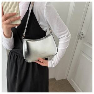 Mirror-finish silver underarm bag with Fashion & Bags text shown on a shoulder