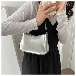Detail shot of the glossy silver shoulder bag with metallic texture and brand lettering