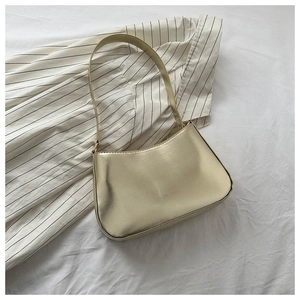 Close-up of champagne metallic underarm bag with Fashion & Bags silver lettering