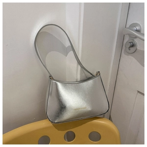 Detail of silver metallic shoulder bag featuring embossed Fashion & Bags lettering