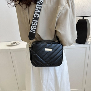 Modern black quilted crossbody camera bag with adjustable wide logo strap for women