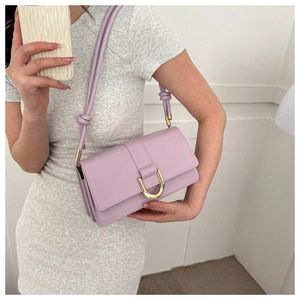 Detail of lavender PU leather crossbody bag with iconic gold D-buckle and knotted strap