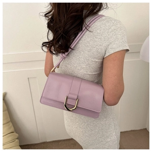 Detail of lavender PU leather crossbody bag featuring a golden D-ring buckle and knotted strap
