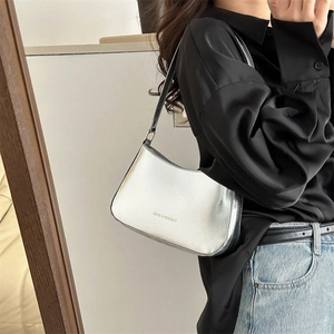 Chic silver metallic underarm bag with fashion print shown on model in mirror view