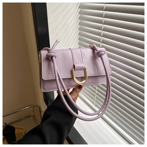 Detailed close-up of a lavender PU leather crossbody bag with a gold U-shaped metal clasp