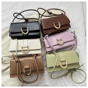 Flat lay of baguette shoulder bags in six various colors with gold U-shaped buckles