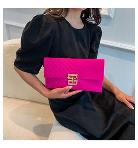 Magenta gesteppte Umschlag-Clutch mit V-Stich und Goldverschluss, getragen von einem Model