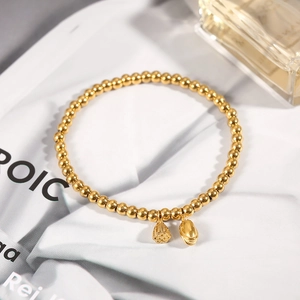 Golden beaded lotus pod bracelet with ruyi charm on a minimalist lifestyle background