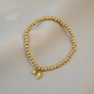 Gold beaded bracelet with lotus bud charms and polished minimalist design for women