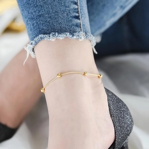 Minimalist rose gold titanium steel anklet with five polished lucky beads on a snake chain