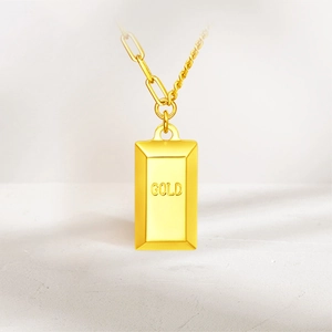 Detailed macro view of 18k gold plated bar pendant necklace with unique asymmetric chain