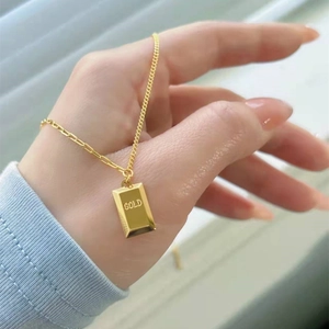 Polished 18k gold-plated bar necklace with GOLD engraving worn as a stylish choker
