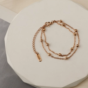 Double-layered 18K rose gold bead bracelet with polished spheres and lobster clasp