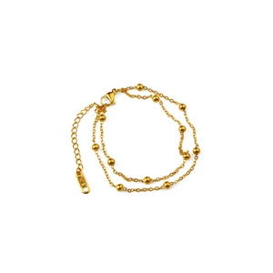 Double-layered 18K gold beaded chain bracelet with lobster clasp on white background