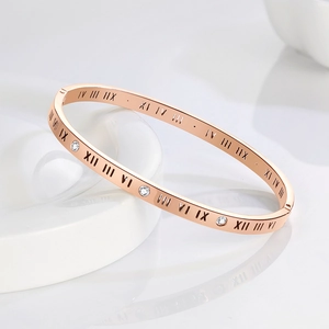 Rose gold Roman numeral bangle featuring hollow design and sparkling zircon accents