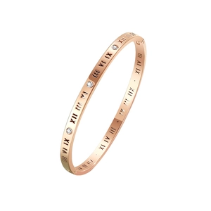 Rose gold Roman numeral bangle with sparkling diamonds on a clean white background