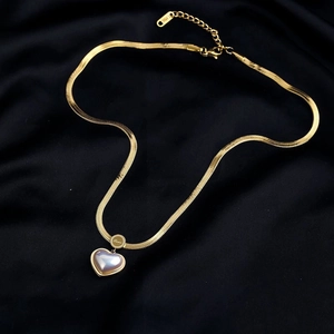 Elegant gold snake chain necklace featuring a 3D heart pendant on black velvet background
