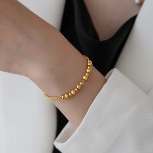 Elegant gold titanium steel bracelet featuring alternating frosted and polished beads